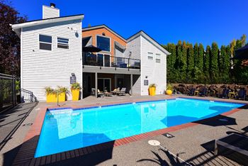A large swimming pool in front of a house